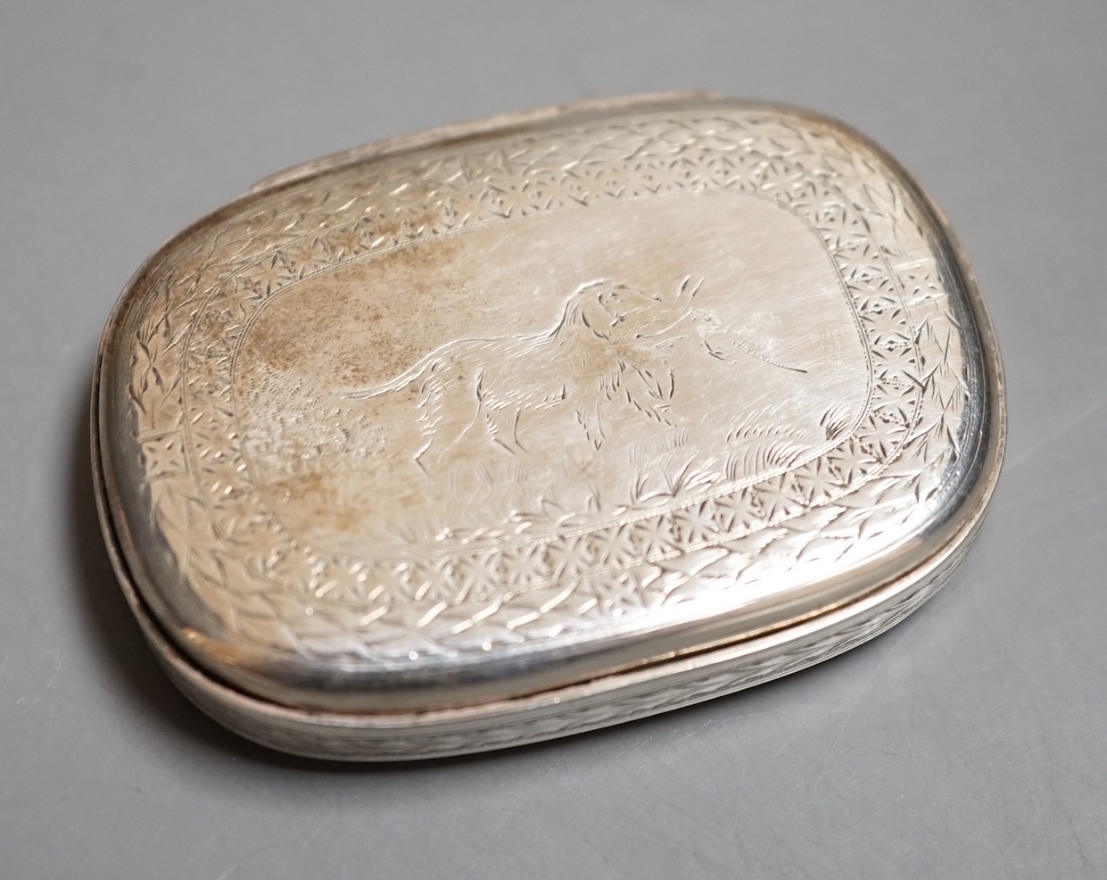 A Victorian Scottish silver oval vesta case, John Muirhead & Son, Glasgow, 1869, with engraved inscription and cover with hunting dog and game bird, 58mm.